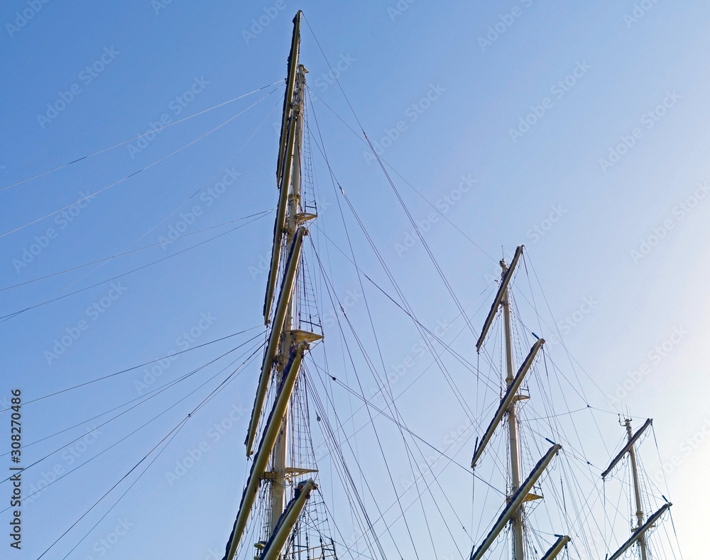 Masts and rigging of a sailing ship against sky Masts and rigging of a sailing ship against sky