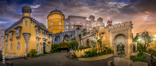 Sintra Pena palace popular destination with dramatic sky during winter sunset in Portugal with colorful buildings