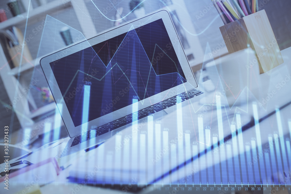 Forex Chart hologram on table with computer background. Double exposure. Concept of financial markets. Forex Chart hologram on table with computer background. Double exposure. Concept of financial markets.