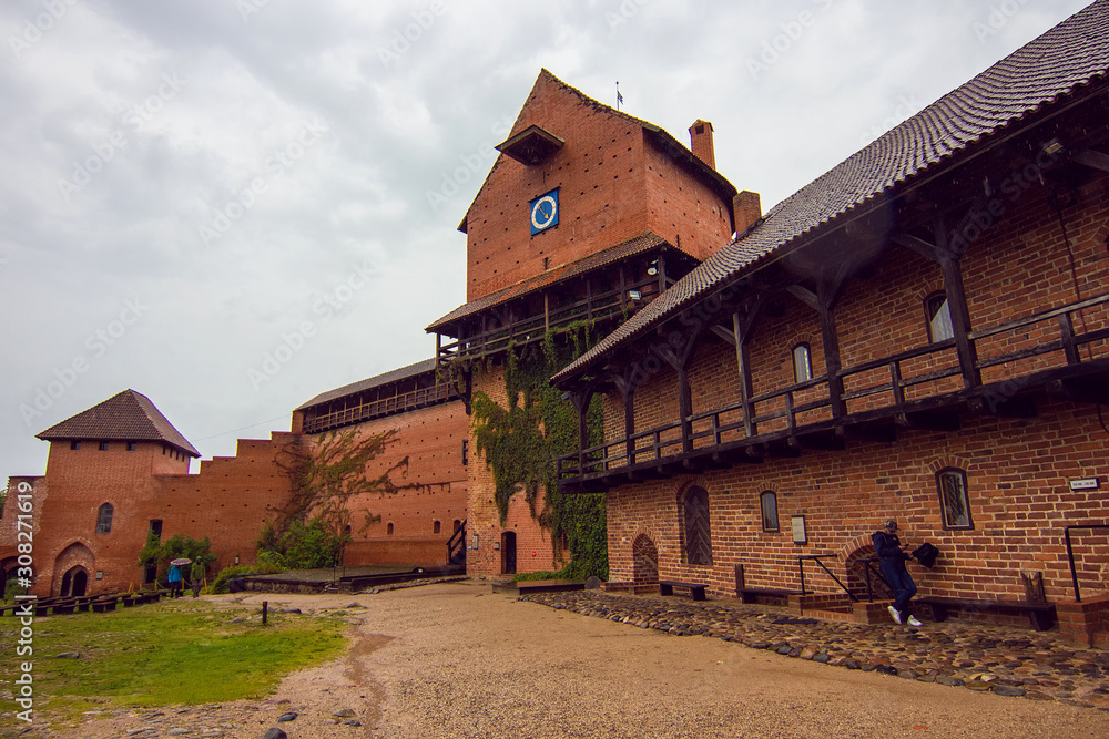 Courtyard of medieval Turaida Castle in cloudy, foggy and rainy day, Sigulda, Latvia. It is reconstructed castle, which was founded in 1214. Soft selective focus