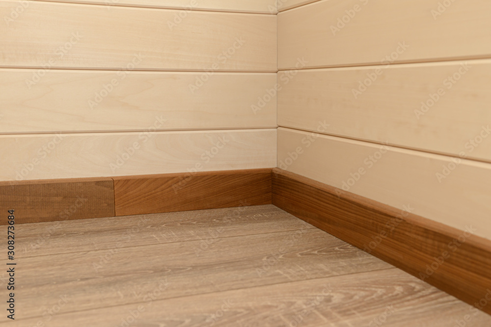 Corner of the house with wooden floor and walls Corner of the house with wooden floor and walls