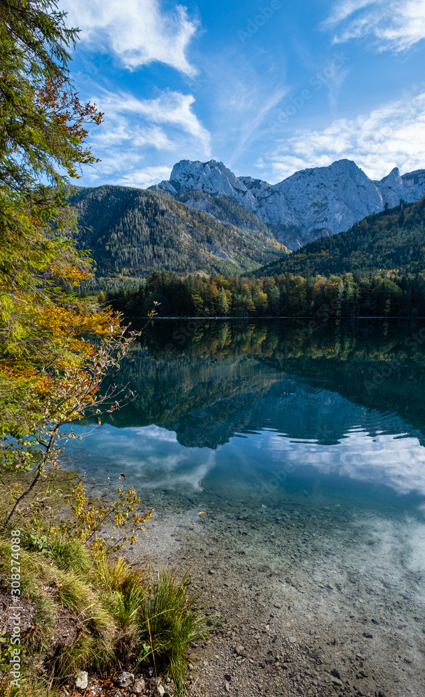 Peaceful autumn Alps mountain lake with clear transparent water and reflections. Langbathseen lake, Upper Austria.