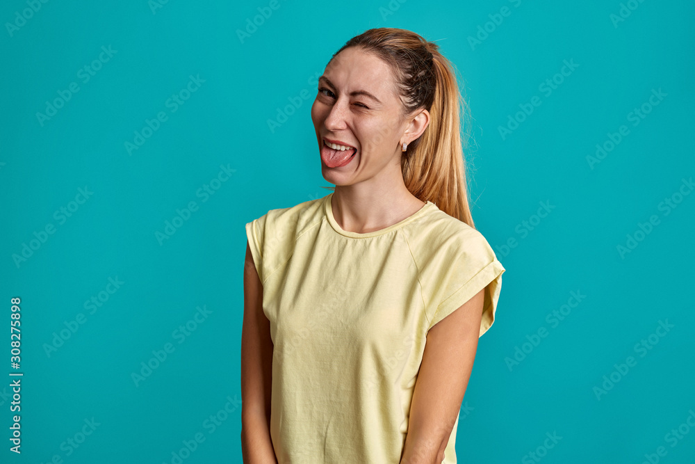 Beautiful portrait of a young girl on a blue background. Young emotional smile and surprised, angry woman screaming. Beautiful portrait of a young girl on a blue background. Young emotional smile and surprised, angry woman screaming.