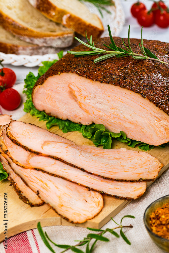 Cajun Style Roasted Turkey Breast Deli Sliced Lunch Meat on White Wooden Background. Selective focus. Cajun Style Roasted Turkey Breast Deli Sliced Lunch Meat on White Wooden Background. Selective focus.
