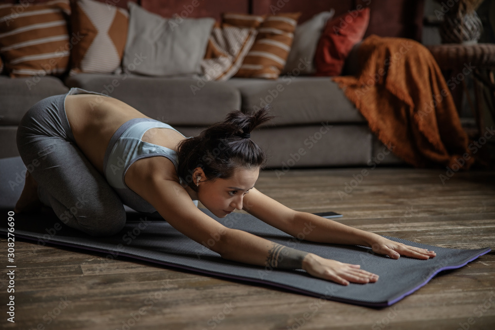 Young woman is practicing advanced yoga at home Young woman is practicing advanced yoga at home