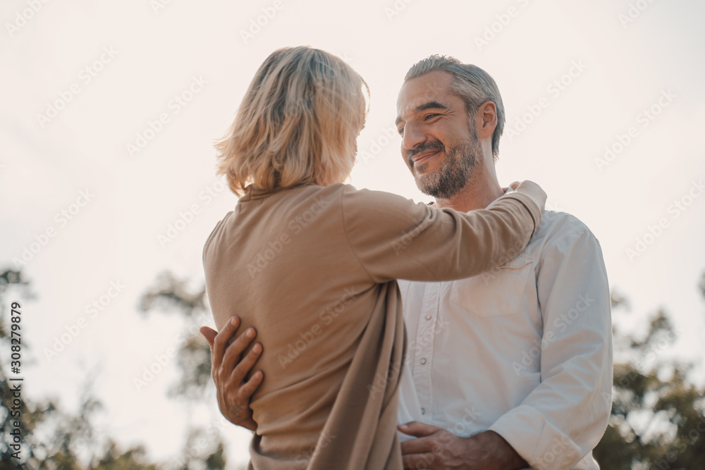 Older Lover and dating concept.Beautiful Senior couple romantic dancing in park.mature couple in summer park.Elderly man and old woman in love dancing outdoors. - obrazy, fototapety, plakaty 