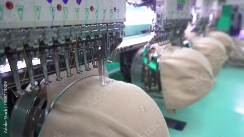 Footage of Embroidery machine needle on embroidery cap in Textile Industry at Garment Manufacturers (selective focus and soft focus)