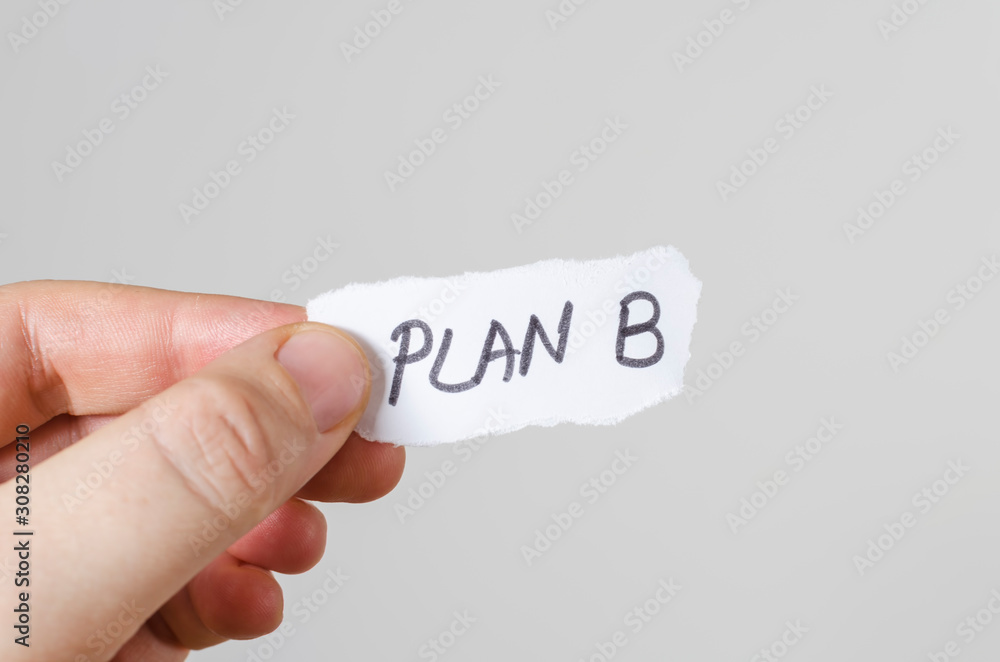 plan b written on paper in hand. Plan B paper is meaning to someone who has no 2nd plan or another option or way to go thru. plan b written on paper in hand. Plan B paper is meaning to someone who has no 2nd plan or another option or way to go thru.