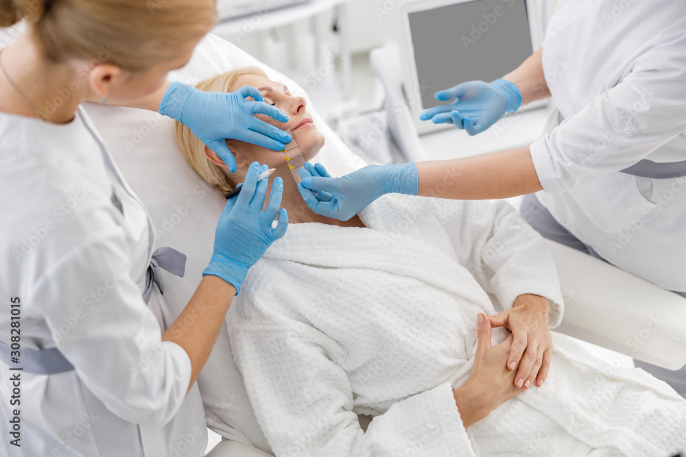 Specialists choosing a place for lifting procedure Specialists choosing a place for lifting procedure