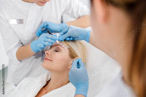 Specialist and female patient in a beauty salon