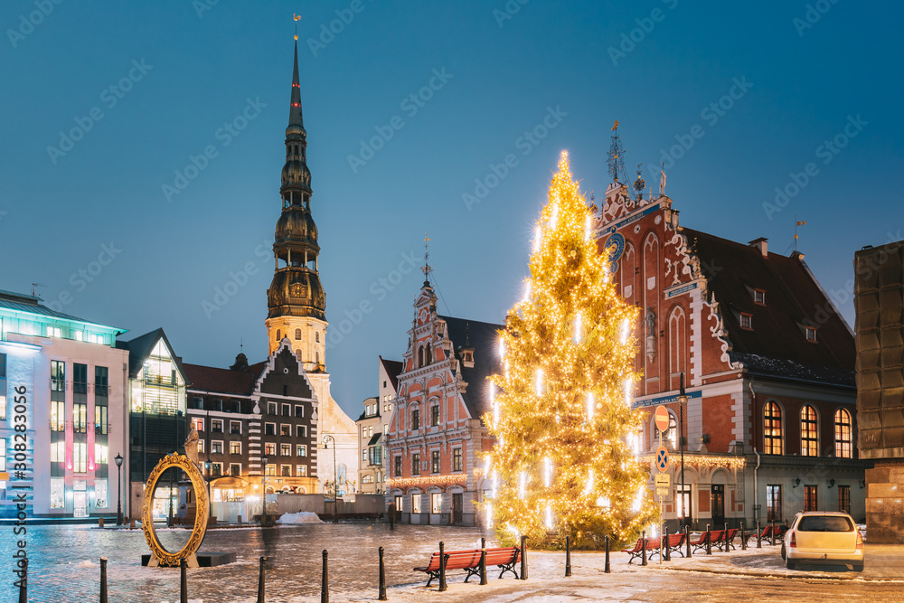 Riga, Latvia. Town Hall Square, Popular Place With Famous Landmarks On It In Bright Evening Illumination In Winter Twilight. Winter New Year Christmas Holiday Season