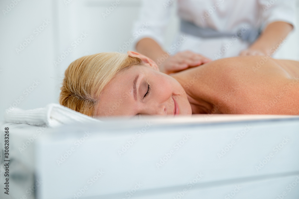 Smiling woman having classical neck and back massage Smiling woman having classical neck and back massage