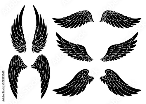 Set of hand drawn bird or angel wings of different shape in open position. Black doodle wings set