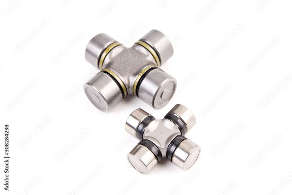 The crossbar of the steering shaft,The propeller shaft yoke for cars isolated on white background. New car parts. The crossbar of the steering shaft,The propeller shaft yoke for cars isolated on white background. New car parts.