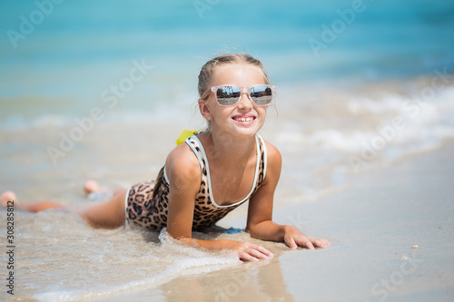 Happy child against blue sky background. Summer vacation concept