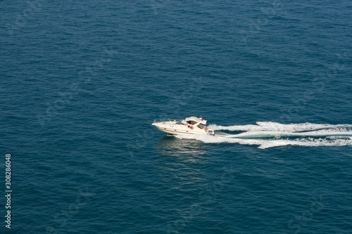 The speedboat traveling fast in the Mediterranean Sea and the trail it left behind © ali