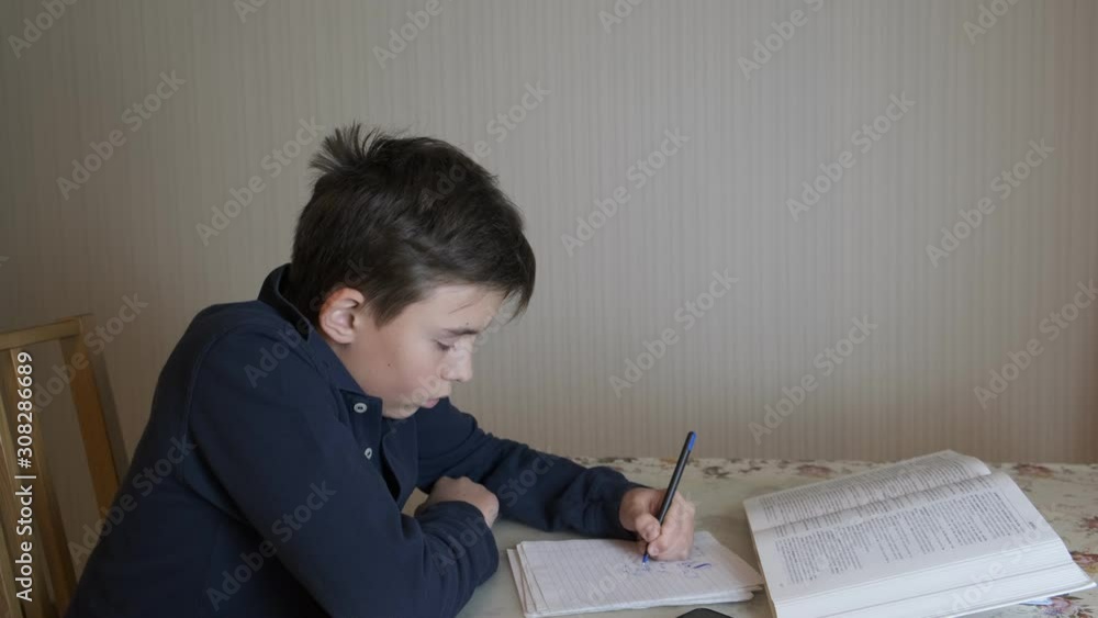 the boy at the table prepares for lessons the boy at the table prepares for lessons