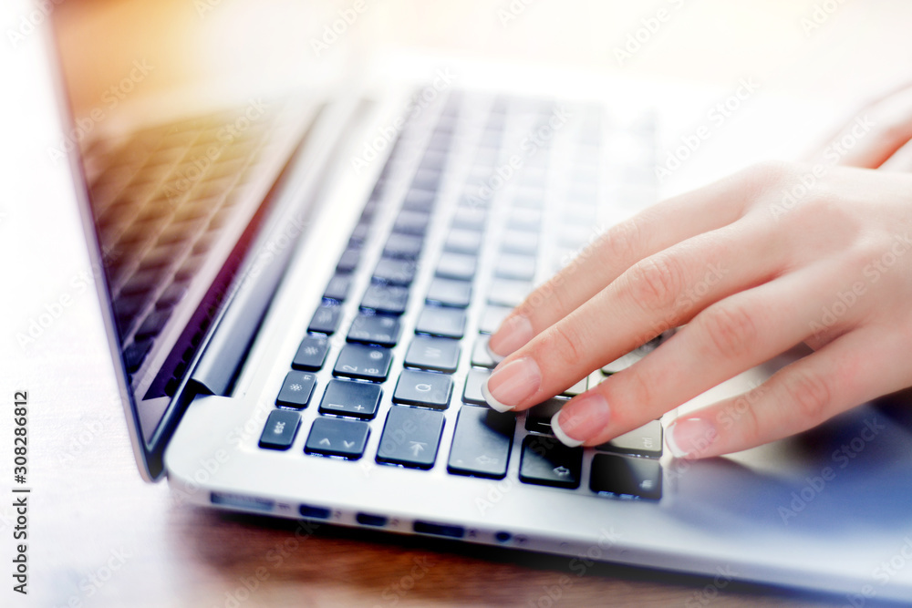 Woman working on modern computer. Person buying online at internet. Laptop keyboard detail with hands. Woman working on modern computer. Person buying online at internet. Laptop keyboard detail with hands.