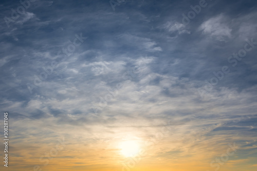 Fototapeta Naklejka Na Ścianę i Meble -  evening sun and blue cloudy sky, dramatic sunset background