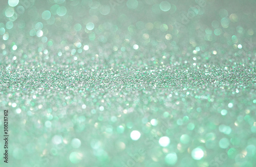 Beautiful Abstract Sparkle Glitter Lights Background. Soft and Light Green Emerald. Shine Bokeh Effect. For party, holidays, celebration. Good for New Year and Christmas Card