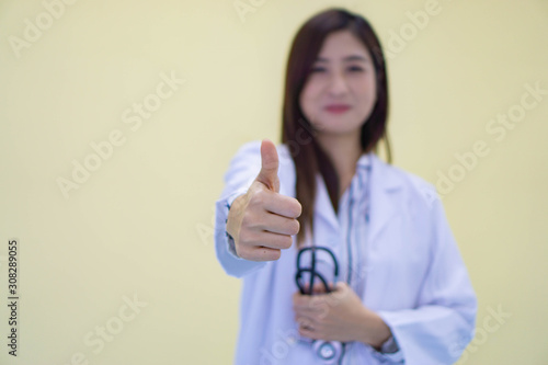 young female doctor with thumb up and stethoscope