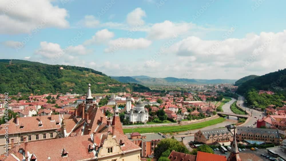 Scenic and smooth drone aerial flight towards the old city of Sighisoara in Romania Scenic and smooth drone aerial flight towards the old city of Sighisoara in Romania