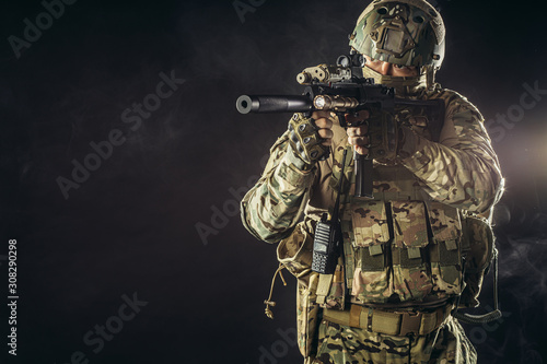 military forces concept., young brave soldier holding weapon looking for danger to protect humanity, soldier sniper in green uniform