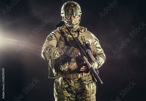 young caucasian military man in camouflage protect people from war, protect his country. brave soldier look at camera isolated in studio