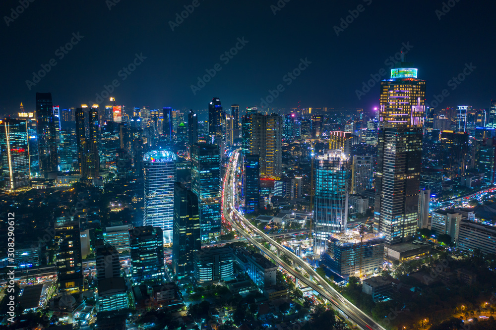 Aerial view of glowing skyscrapers beside highways