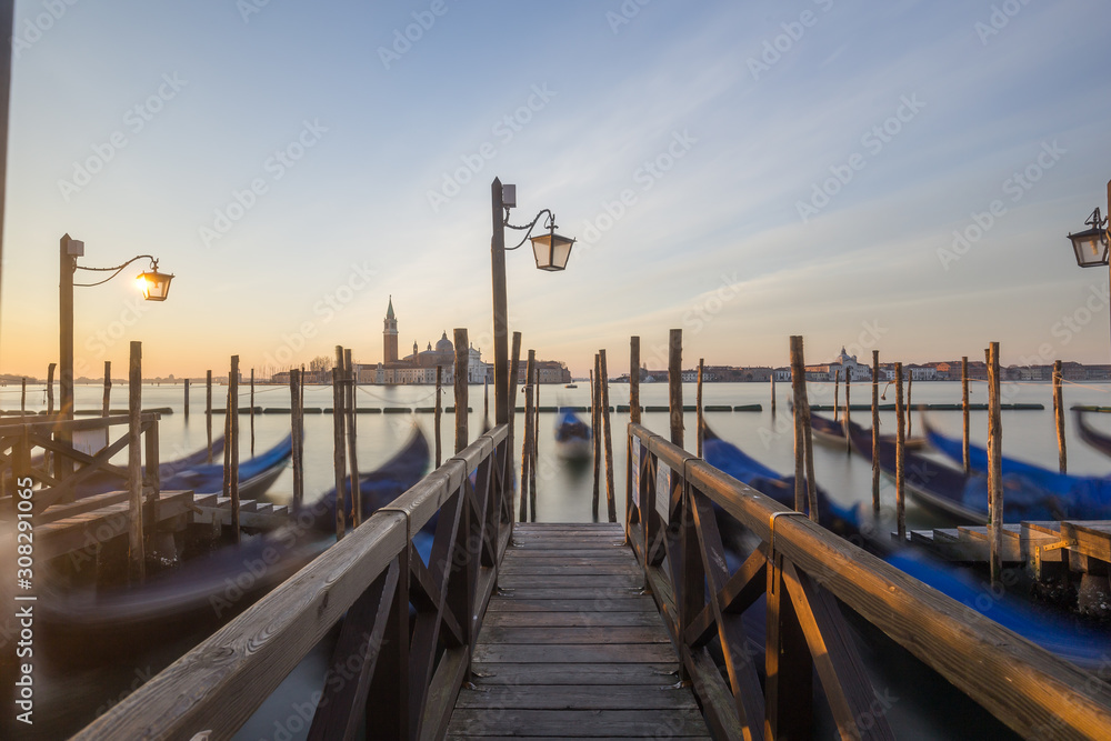 Gondolas docked at the pier in Venice