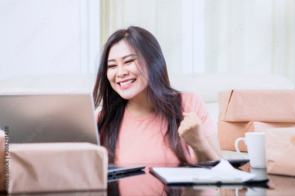 Asian woman giggling after finishing her jobs Asian woman giggling after finishing her jobs