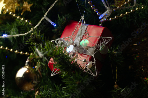 Christmas gift with decorations hanging from Christmas tree