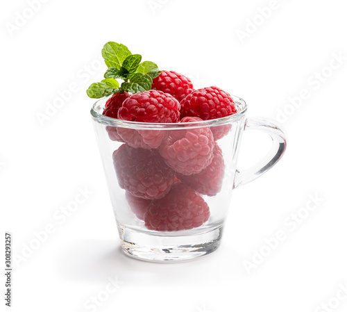 Lot of fresh raspberry in glass cup isolated on white