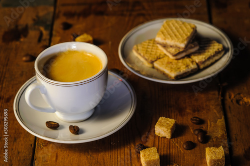 cup of  coffee and cookies on wooden table