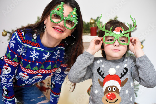 Mother and son play under a Christmas tree. Happy family, Boy with a mom wait a New Year
