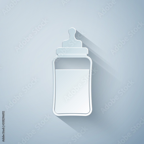 Paper cut Baby bottle icon isolated on grey background. Feeding bottle icon. Milk bottle sign. Paper art style. Vector Illustration