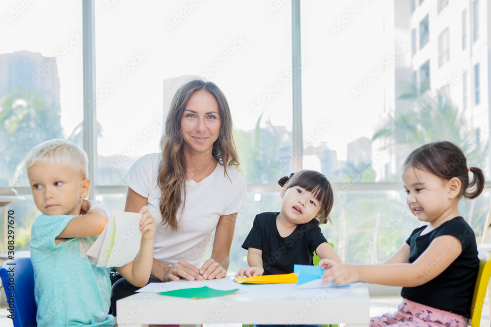 Teacher taking photo while her pupils folding