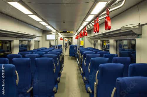 empty interior of an electric train car with blue passenger seats in perspective in Moscow Russia
