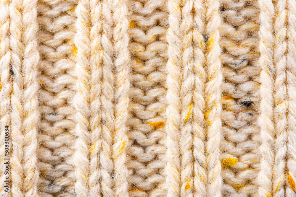 Texture of Wool Knit Beige Fabric Interspersed with Yellow Yarn. Sweater Background Close-Up View Texture of Wool Knit Beige Fabric Interspersed with Yellow Yarn. Sweater Background Close-Up View