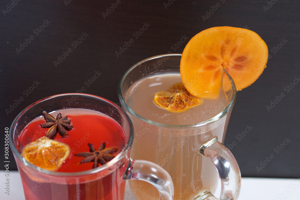 Drink red and yellow in glass goblets. Anise stars, dried mandarin rings, a slice of persimmon float in it. Drink red and yellow in glass goblets. Anise stars, dried mandarin rings, a slice of persimmon float in it.