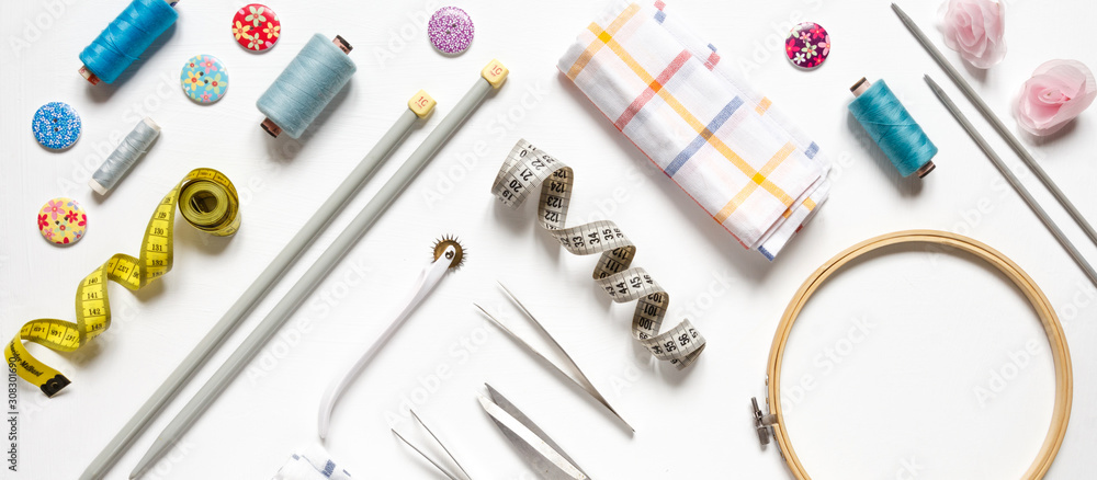Sewing flat lay top view Composition with threads and sewing accessories on wnite background, flat lay banner Sewing flat lay top view Composition with threads and sewing accessories on wnite background, flat lay banner
