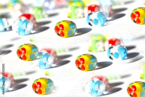 Beautiful colorful original background made of handmade lampwork beads. Glass beads with flowers.