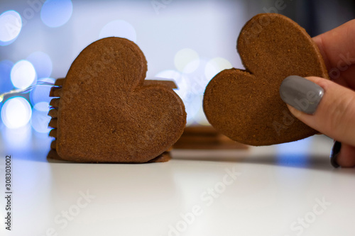 Macro close-up of tasty, heart shaped Christmas gingerbread cookies and bokeg christmas light bubble background. Shallow depth of field. photo