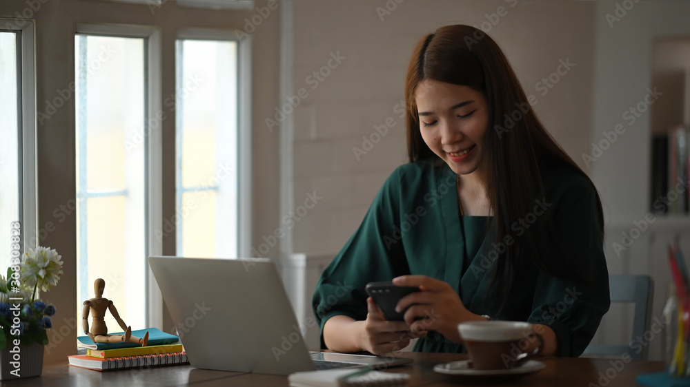 Asian woman using her mobile phone and enjoy moment. Asian woman using her mobile phone and enjoy moment.