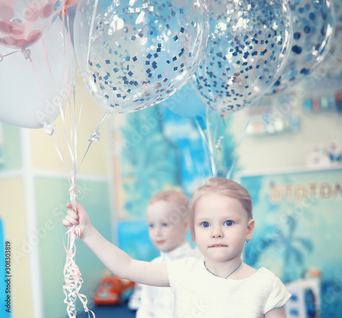 A small child is playing with toy photo