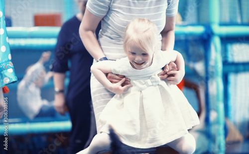 A small child is playing with toy photo