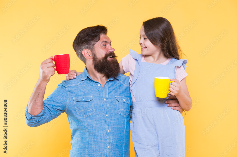 Bearded man and happy girl holding mugs. Father and daughter hot drink. Drink water. Drink fresh juice. Breakfast concept. Good morning. Having coffee together. Healthy lifestyle. Family drinking tea