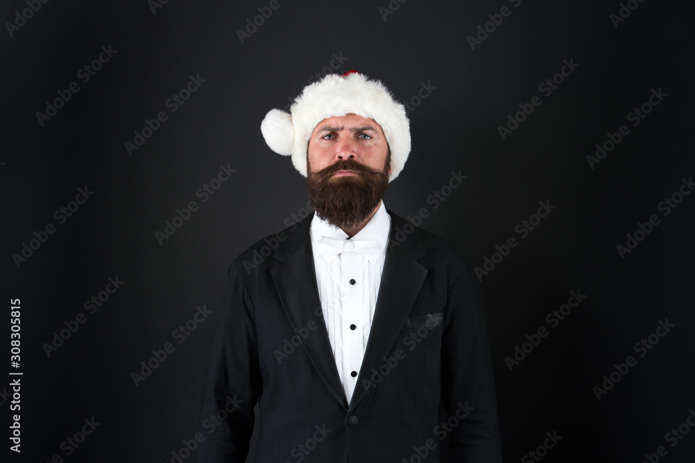 The busy season is December. Serious santa businessman. Businessman celebrate Christmas and new year. Businessman dressed for office party. Businessman wear santa hat with formalwear