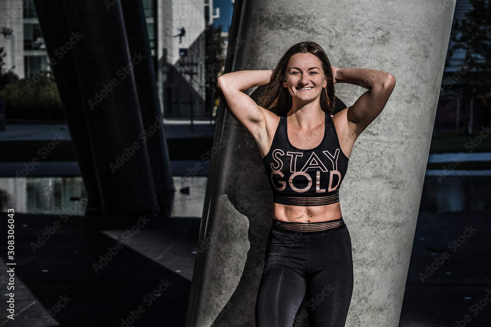 Fototapeta premium Beautiful girl - fitness trainer in black outfit