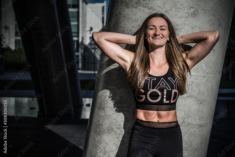 Fototapeta premium Beautiful girl - fitness trainer in black outfit